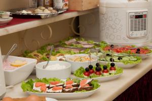 a buffet with many plates of food on a table at Chekhov hotel by Original Hotels in Yekaterinburg