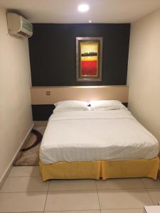 Postel nebo postele na pokoji v ubytování One Avenue Hotel