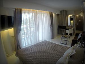 Ένα ή περισσότερα κρεβάτια σε δωμάτιο στο AKRON Luxury Holidays