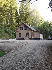 a house with a gravel driveway in front of it at Mill Hause Apart 1 in Druskininkai