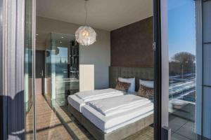 a bedroom with a bed and a chandelier at DECK 8 DESIGNHOTEL.SOEST in Soest