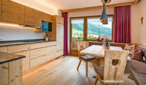 a kitchen and dining room with a table and chairs at Fernblick in Mayrhofen