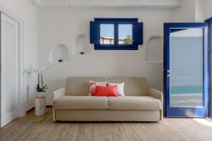 a living room with a couch and a blue mirror at Sea Dream Luxury Home in Fira