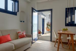 a living room with a couch and a table at Sea Dream Luxury Home in Fira