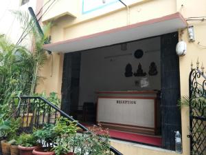 a store front of a building with a sign that says meditation at Srinivasa Lodge in Hyderabad