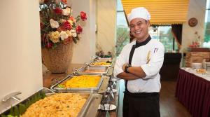 a chef standing in front of a buffet of food at Hotel Seri Malaysia Lawas in Lawas +31 photos