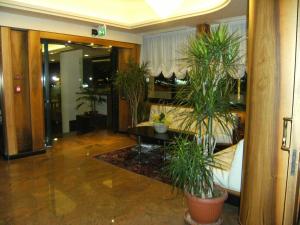 a lobby with potted plants in a building at Hotel Europa in Bibione +38 photos