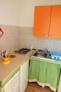 a kitchen with a sink and a stove at Case vacanza Gli Oleandri in Otranto