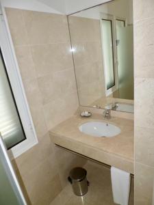 a bathroom with a sink and a mirror at Santa Cruz Ocean Villa in Gaula +28 photos