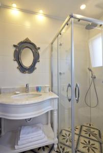 a bathroom with a sink and a glass shower at Eritrina Alacati in Alacati