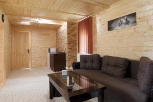 a living room with a couch and a table at Centrul de Echitatie Poiana Brasov in Poiana Brasov