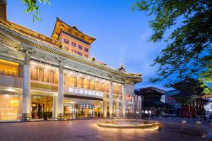 a large building with a fountain in front of it at Jin Jiang West Capital International Hotel the Bell and Drum Tower Muslim quarter & Metro Line 6 & indoor swimming pool & self-service free laundry room in Xi'an