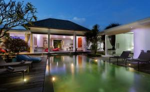 a villa with a swimming pool at night at Villa Bahia by Optimum Bali Villas in Seminyak