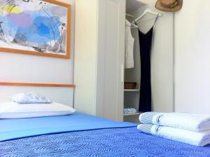 a bedroom with a blue bed and a closet at Apartment Adriana in Supetar +22 photos