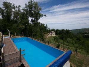 a large blue swimming pool with a view at Val Giardino Vintage Cottage in Roccamorice