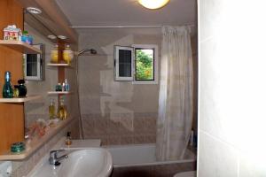 a bathroom with a sink and a tub and a shower at Casa Nea in El Rosario +36 photos