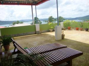 a bench on a patio with a view of the water at The Port Vista in Port Blair