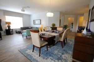 a dining room and living room with a table and chairs at Cayview Condo #231537 in Orlando