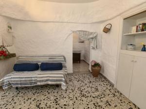 a bedroom with a bed with blue pillows on it at Belvilla by OYO Il Tesoro in Cisternino