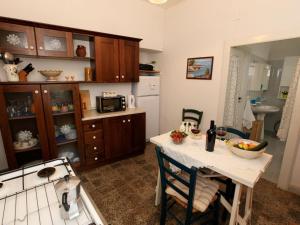 a kitchen with a table and a sink and a stove at Belvilla by OYO Il Tesoro in Cisternino