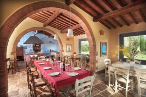 a dining room with a table and a kitchen at Villa - Podere Monti in Sant'Albino