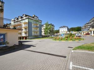 a parking lot in a city with some buildings at Apartament Na Wydmie - parter in Ustka