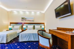 Łóżko lub łóżka w pokoju w obiekcie Grein Hotel