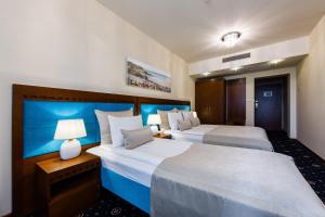 Łóżko lub łóżka w pokoju w obiekcie Grein Hotel