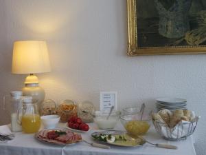 a table with food on it with a plate of food at Hotel-Pension SCHLOSS -MIRAMAR in Bad Elster