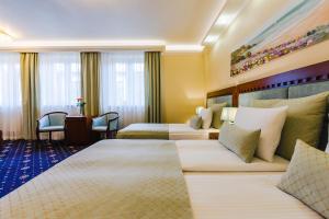 Łóżko lub łóżka w pokoju w obiekcie Grein Hotel