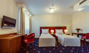 Łóżko lub łóżka w pokoju w obiekcie Grein Hotel