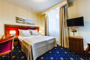 Łóżko lub łóżka w pokoju w obiekcie Grein Hotel