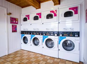 a row of washing machines in a laundry room at Newquay Bay Holiday Resort by Away Resorts in Newquay