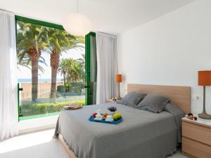 a bedroom with a bed with a tray of fruit on it at Apartment Las Burras in San Agustin