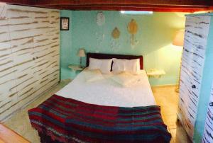 A bed or beds in a room at Mariza's traditional house 1900