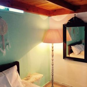 A bed or beds in a room at Mariza's traditional house 1900