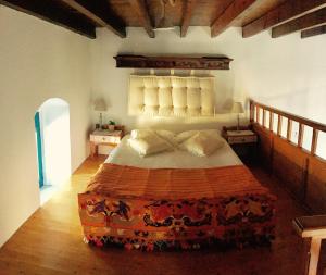 A bed or beds in a room at Mariza's traditional house 1900