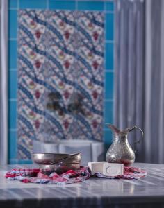 a table with a vase and a plate on it at Palmin Hotel in Kusadası