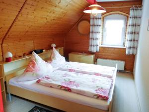 a bedroom with a bed in a wooden room at Ferienwohnung Baade in Dresden