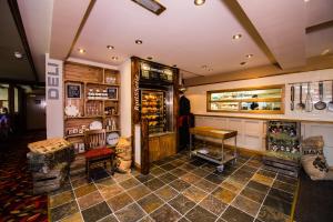 a room with a store with a counter and chairs at Starling Cloud in Aberystwyth