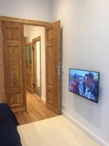 a television hanging on a wall in a room at City-Apartment Berlin Charlottenburg in Berlin