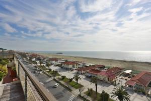 a beach with a large building on top of it at Hotel Piccadilly in Lido di Camaiore