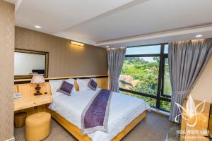 Postel nebo postele na pokoji v ubytování Hoa Ngoc Lan - The Orchid Villa Dalat