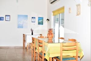 a dining room with a table and chairs at Lefkorama in Lefkos Karpathou