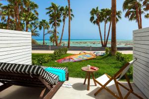 a patio with a table and chairs and the beach at INNSiDE by Meliá Fuerteventura – Adults Only in Costa Calma