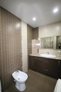 une salle de bain avec toilettes, lavabo et miroir dans l'établissement Rent Inn Yerevan on Sakharov Square, à Erevan