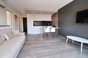 a living room with a couch and a table at Residence ACQUA LINDA Porticcio in Porticcio
