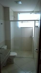 a bathroom with a glass shower with a toilet at Hotel e Restaurante Bordignon in Joaçaba