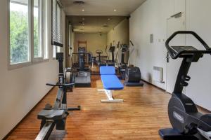 a gym with treadmills and machines in a room at Novotel Senart Golf De Greenparc in Saint-Pierre-du-Perray