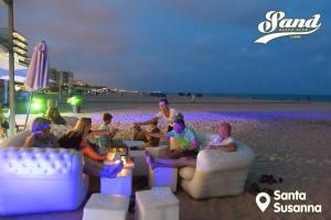 a group of people sitting on chairs on the beach at htop Royal Sun Suites 4Sup - Fun in Santa Susanna +34 photos